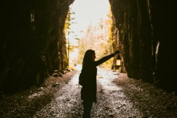 woman standing inside cave