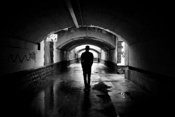 silhouette photo of a man in a tunnel