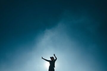 silhouette of woman against moonlit sky