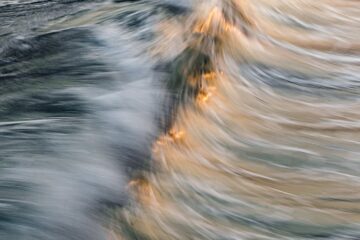 sunset light reflecting in sea wave