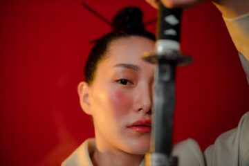 a woman holding a katana