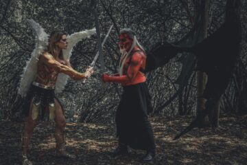 woman and man in cosplay costumes in forest